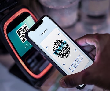 Person scanning QR code with a smartphon